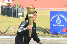 Anita, Commonwealth Games wrestling gold medallist, carries the baton during the inauguration of the 42nd Haryana Police Games in Madhuban