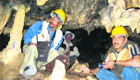 Scientists examine a cave at Dharamjali in Pitthoragarh district.