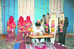 The Dera Sacha Sauda chief with three couples in Sirsa