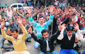 Members of the J&K PDD Daily Wagers Union protest in support of their demands in Jammu