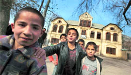 Afghan children play in front of a school in Kabul on Monday.