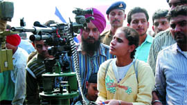 A visitor looks at a machine gun exhibited among other weapons during an Army fair in Bathinda on Tuesday.