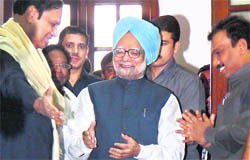 PM Manmohan Singh with ex-Telecom Minister A Raja (right) at a function in New Delhi on Tuesday. It was here that the PM patted Raja on the back.