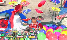 A woman sells handmade toys during the Jhiri fair on the outskirts of Jammu