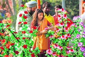 A girl sells artificial flowers along the Akhnoor Road in Jammu