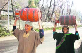 In the absence of home delivery of LPG refills, women in the Ganderbal area have to carry gas cylinders on their heads