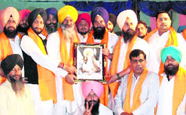 Gurjinder Singh (extreme top right) shares the dais with Agriculture Minister Sucha Singh Langah (wearing yellow turban) at a political function on the Jalandhar-Wagah bypass on November 11.