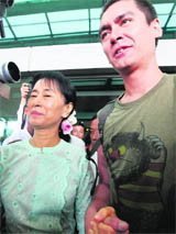 Myanmars Aung San Suu Kyi with her son Kim Aris at the Yangon airport on Tuesday after the countrys ruling junta granted him a visa. Aris is the younger 
