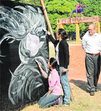 Artistes give final touches to a painting ahead of the Chandigarh Carnival