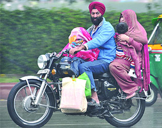 A couple caught in the sudden rain in New Delhi on Wednesday. Tribune photo