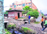 Chemical waste from Divya Pharmacy (big building in the backdrop) flows towards Devpura and finally into the Ganga.