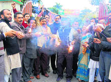 BJP workers celebrate the victory of the JD(U)-BJP combine in the Bihar Assembly elections by exploding crackers in Dehradun on Wednesday
