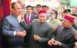 Chief Minister P K Dhumal offers sweets to Union Minister of Health and Family Welfare Ghulam Nabi Azad after laying the stone of the super-speciality wing of the Tanda hospital on Wednesday.