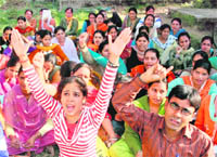 Students of the first semester of MA (Hindi), Directorate of Distance Education, University of Jammu, raise slogans in support of their demands in Jammu on Wednesday. 