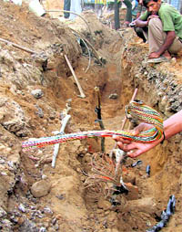 BSNL cables that got snapped during the ongoing construction work on the railway overbridge