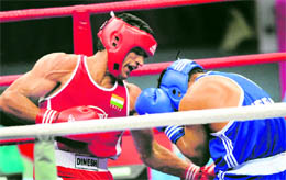 Dinesh Kumar (L) punches Deepak Maharjan of Nepal during the men's +81kg boxing semifinal on Wednesday