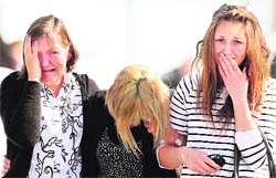 Family members of miners trapped underground in the Pike river coal mine react after learning of a second explosion in the mine in Greymouth on New Zealand's west coast on Wednesday.