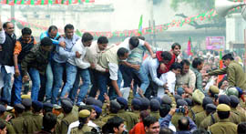 Supporters of the Bharatiya Janata Party try to cross police barricades during a protest near the Delhi Assembly against the alleged corruption in the Commonwealth Games on Thursday.