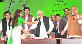 Union Telecom Minister Kapil Sibal and Chief Minister BS Hooda on their cell phones after the launch of the MNP service at Rohtak on Thursday.