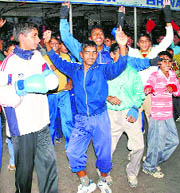 Junior boxers celebrate the victory of Vikas, who won the gold in boxing in the Asian Games, at his native town Bhiwani on Thursday.