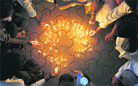 People light candles in memory of 26/11 victims in Mumbai on Thursday.