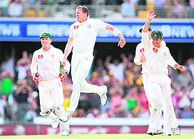 Peter Siddle (C) celebrates dismissing Matt Prior (not pictured) on the way to a hat-trick on the first day of the first Ashes Test in Brisbane on Thursday.