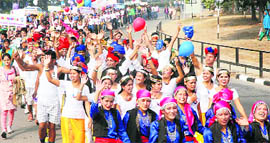 People donning traditional attire wave to the crowd.