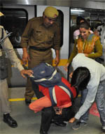 Policemen make two men do sit-ups at Dronacharya Metro Station in Gurgaon for entering the coach reserved for women