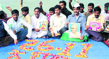 Activists of the Gandhivadi Ekta Manch hold a prayer meeting for Mumbai terror attack victims at Alaknanda Ganga ghat in Haridwar on Friday.