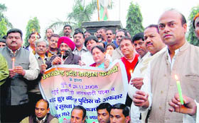 Congress workers hold a candle march in memory of 26/11 victims at the Clock Tower, Dehradun, on Friday.