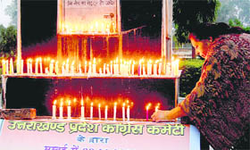 A women lights a candle in memory of 26/11 victims at the Gandhi Park, Dehradun, on Friday.