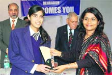 State Education Secretary Manisha Panwar honours a student in Dehradun on Friday.