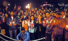 People light candles to pay tributes to the victims of the Mumbai terror attacks, in Shimla on Friday.