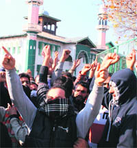 Youths protest during an Idgah chalo march in Srinagar on Friday.