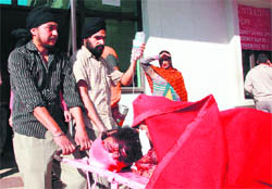 One of the injured in the blast being taken to the GMCH in Jammu on Friday. 