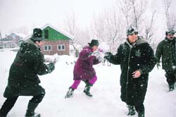 Tourists have fun while playing with snow at Gulmarg.