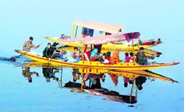 A family living on the Dal Lake heads towards the shore in the Nehru Park area in a shikara in Srinagar.