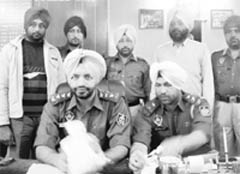 Policemen show the smack that was recovered from a suspect at Mandi Gobindgarh 