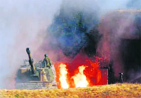 disaster: A South Korean marine base housing its K-9 self-propelled guns burns after it was hit by North Korean artillery shells in this November 23 picture. 