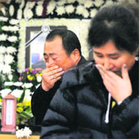 distress: People weep after offering their condolences at a memorial altar for two dead Marines at a hospital in south of Seoul.
