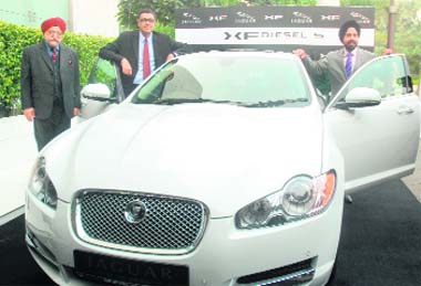 Head of premium car division of Tata Motors Rohit Suri (C), Chairman of AMP Motors BS Anand (L) and Managing Director of AMP Motors Gurmeet Singh Anand at the launch of Jaguar's new Diesel XF car in New Delhi on Friday. Jaguar's Diesel XF with 3.0 litre AJ-V6 Diesel S engine is available at Rs 48.37 lakh (ex-showroom Delhi)