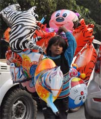 A girl sells toys in a New Delhi area on Saturday.