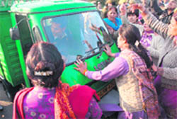 BJP activists stop a tempo during the Chakka Jaam call given by the party at the Tawi bridge in Jammu