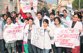 Members of the Jammu Kashmir Physiotherapist Association hold a rally in Jammu