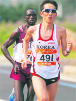 Ji Youngjun from South Korea (491) on way to winning the men's marathon in Guangzhou on Saturday.