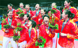 Chinese players celebrate after winning gold in the Womens Volleyball in Guangzhou on Saturday.