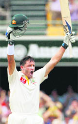 Michael Hussey celebrates his century in Brisbane on Saturday.
