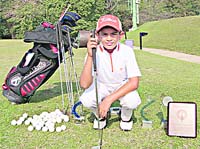 Nine-year-old Aadil Bedi with his golf kit and trophies in Chandigarh.
