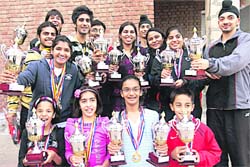 Winners of the badminton meet in a jubilant mood in Chandigarh on Sunday.