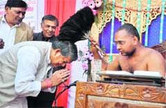 Union Minister of State for Labour and Employment Harish Rawat gets blessings from Jain Saint Vishok Sagar Ji Maharaj at a function in Dehradun on Sunday. 